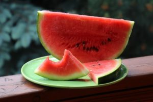 Photo of watermelon slices on a green plate.