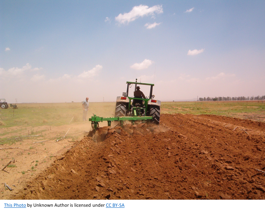 Tractor tilling a field.