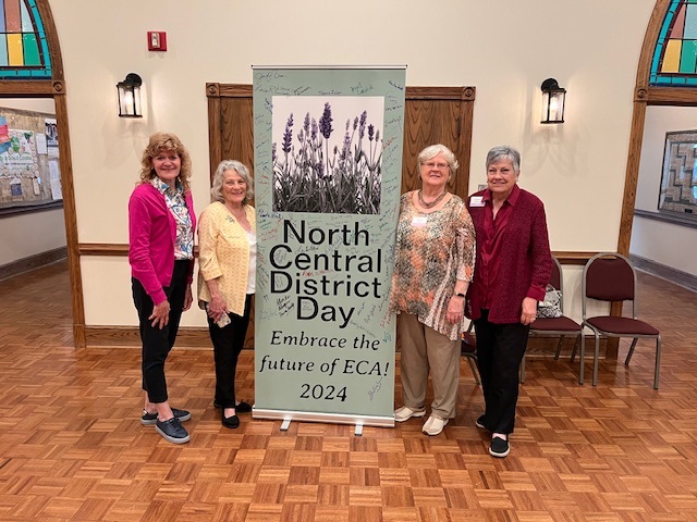 Four women pose with the North Central District Day